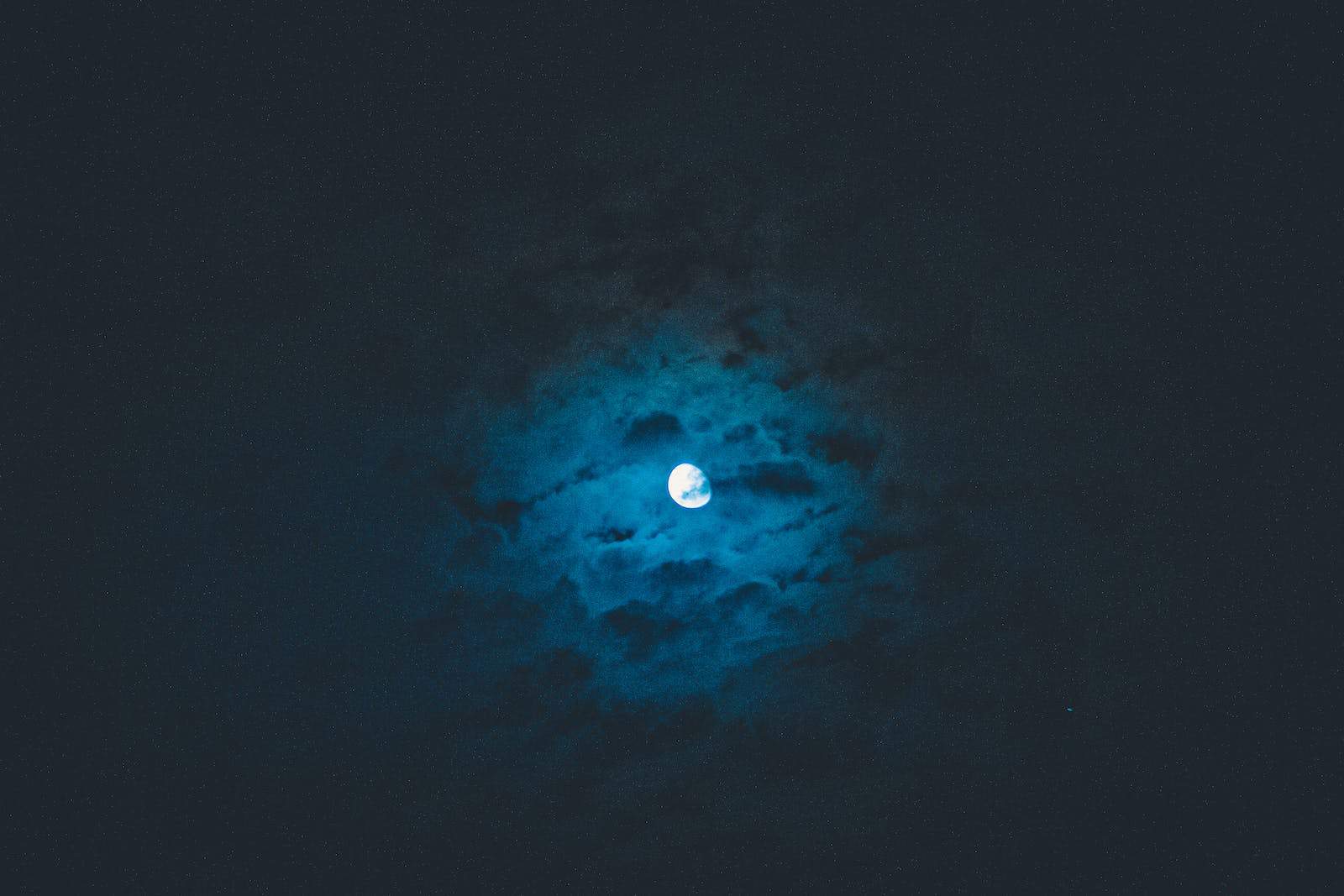 Moon shining on dark sky
