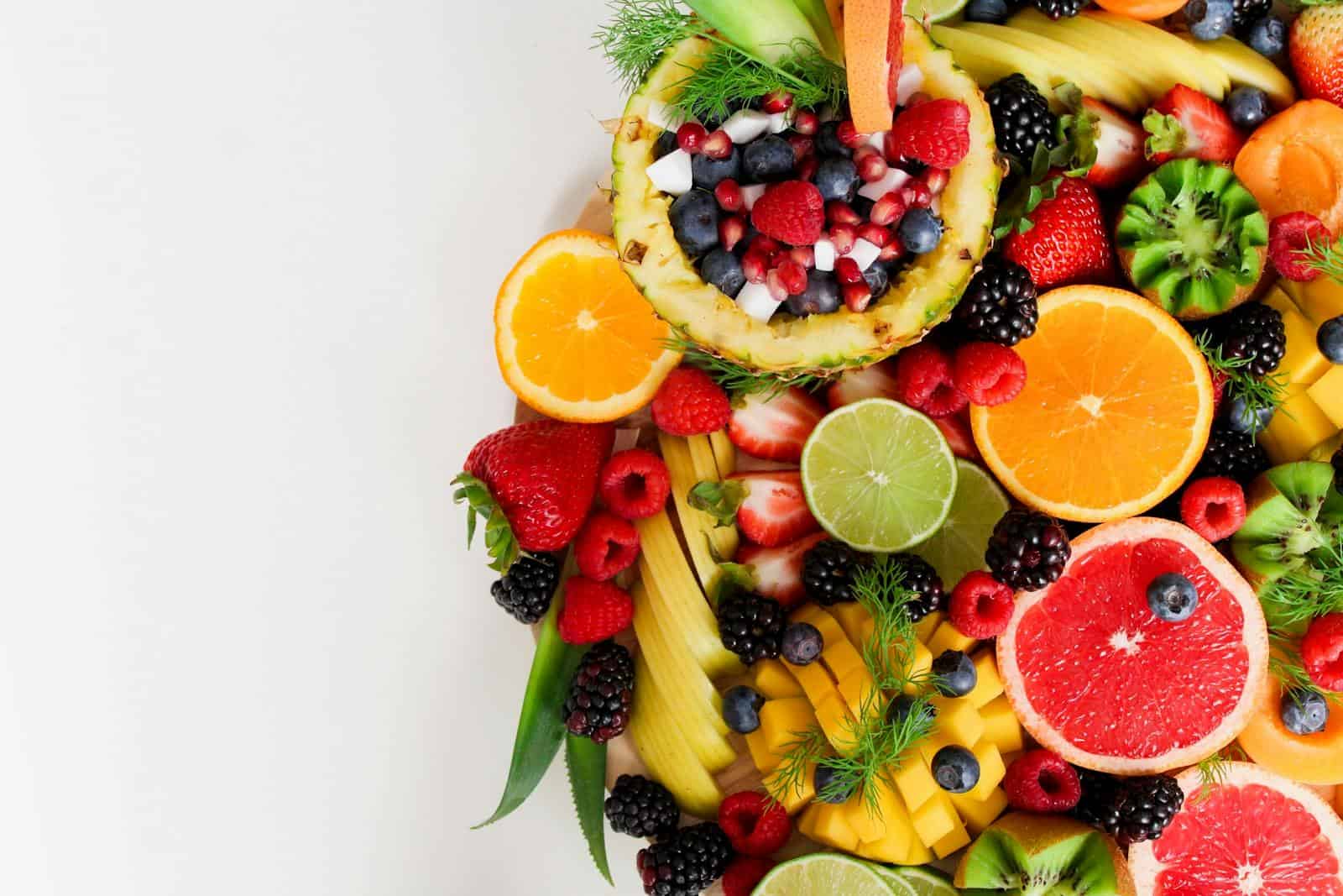 Naturopathy: Holistic Healing, Herbal remedies, Colorful flat lay of assorted tropical fruits including pineapple, berries, and citrus.