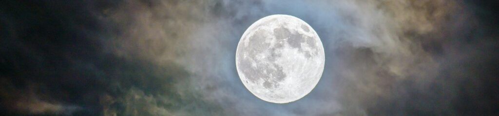 full moon and gray clouds during nighttime
