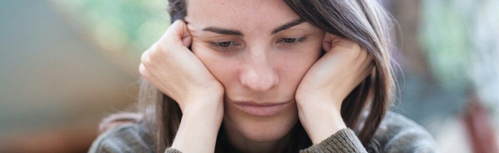 a woman holding her head in her hands