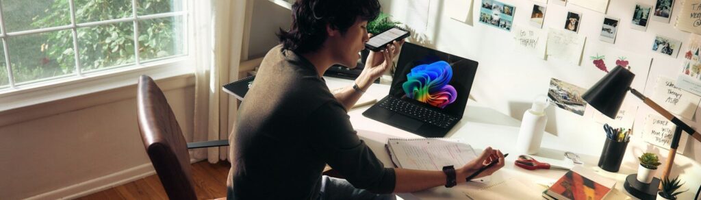 Person working at a desk with a laptop and books