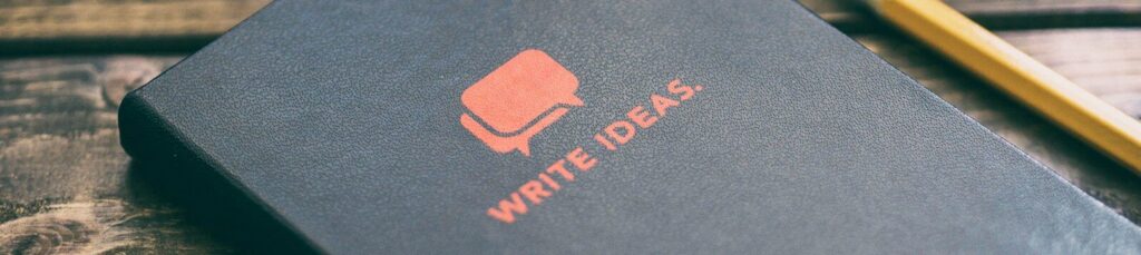 Write Ideas book on brown wooden board