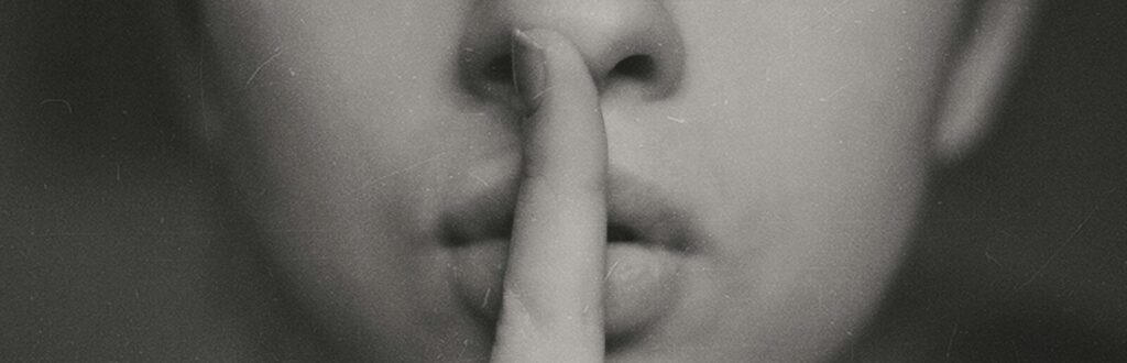 grayscale photo of woman doing silent hand sign
