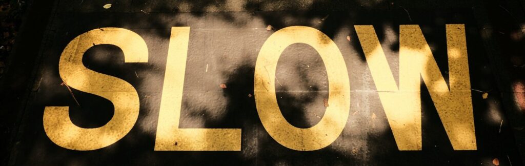 A close up of a street sign with trees in the background