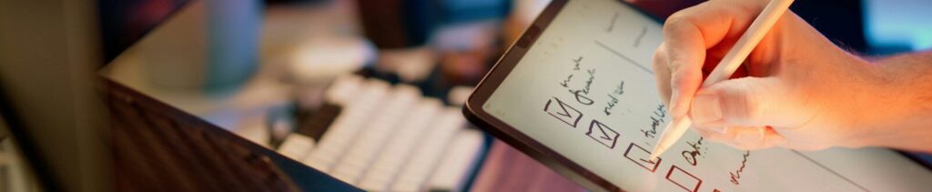 Someone is writing on a tablet with a stylus