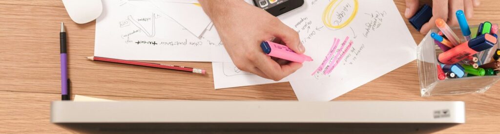 person writing on white paper