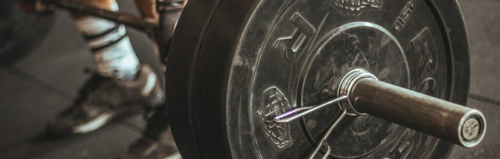 person holding barbell