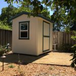 Small garden shed with window and door for storage or workspace.