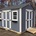Garden shed with double doors, windows, and ramp for easy access, ideal for outdoor storage and orga.