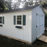 Garden shed with windows, shutters, and ramp for easy access. Perfect for outdoor storage and garden.