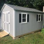 Durable gray garden shed with double doors and windows, ideal for storage and outdoor organization.