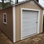 Durable beige garden shed with white trim and roll-up door, ideal for outdoor storage solutions.