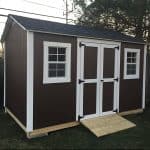 Durable outdoor garden shed with double doors and windows for storage.