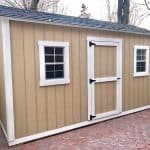 Durable beige garden shed with white trim, double windows, and a secure door.
