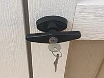 Secure door lock on Atlas Shed with key for safety and protection.