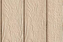 Close-up of beige wooden shed siding with textured wood grain.
