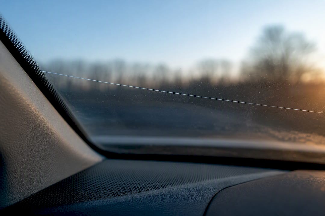 Long stress crack across windshield glass