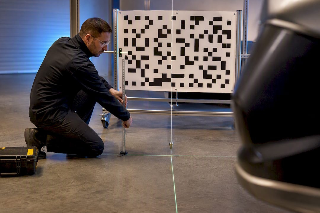 Technician aligning an ADAS calibration target