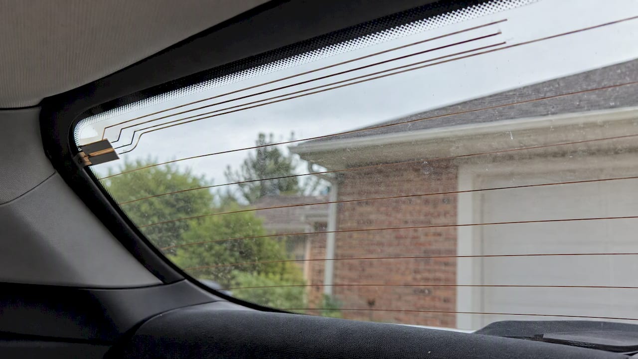 Conductive traces across a vehicle rear window