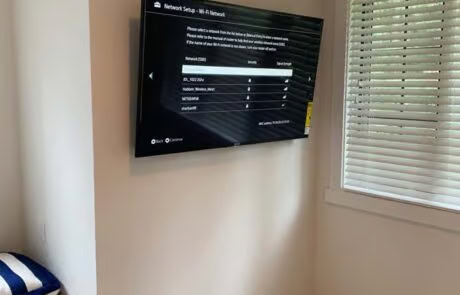 Bedroom smart TV wall-mounted installation with AV system at Suncadia home