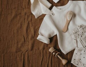 when can i wash baby clothes with mine