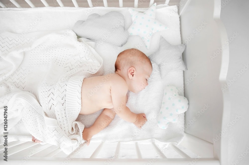 Little baby sleeping in crib , top view