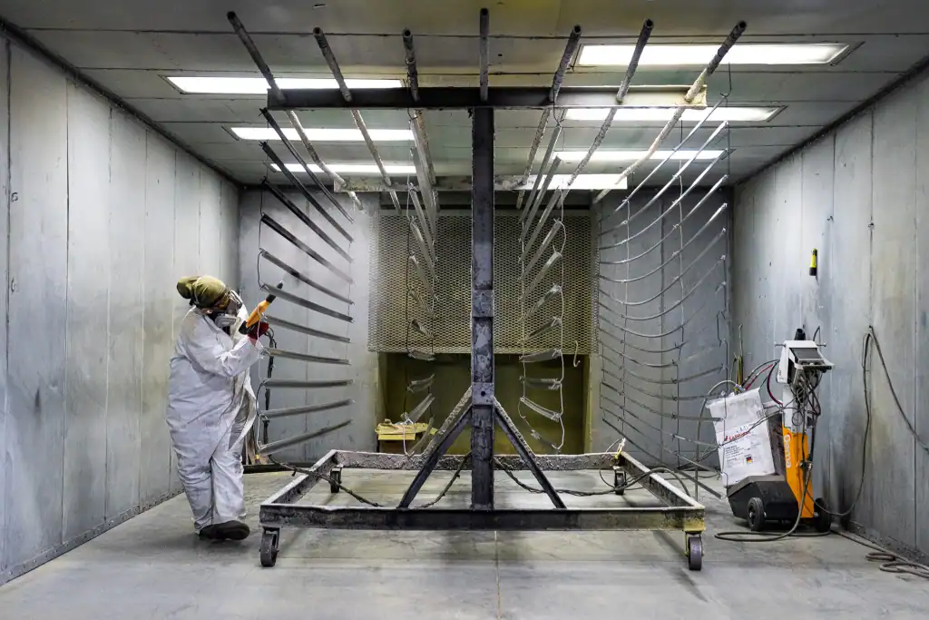 Industrial powder coating application in a controlled environment.