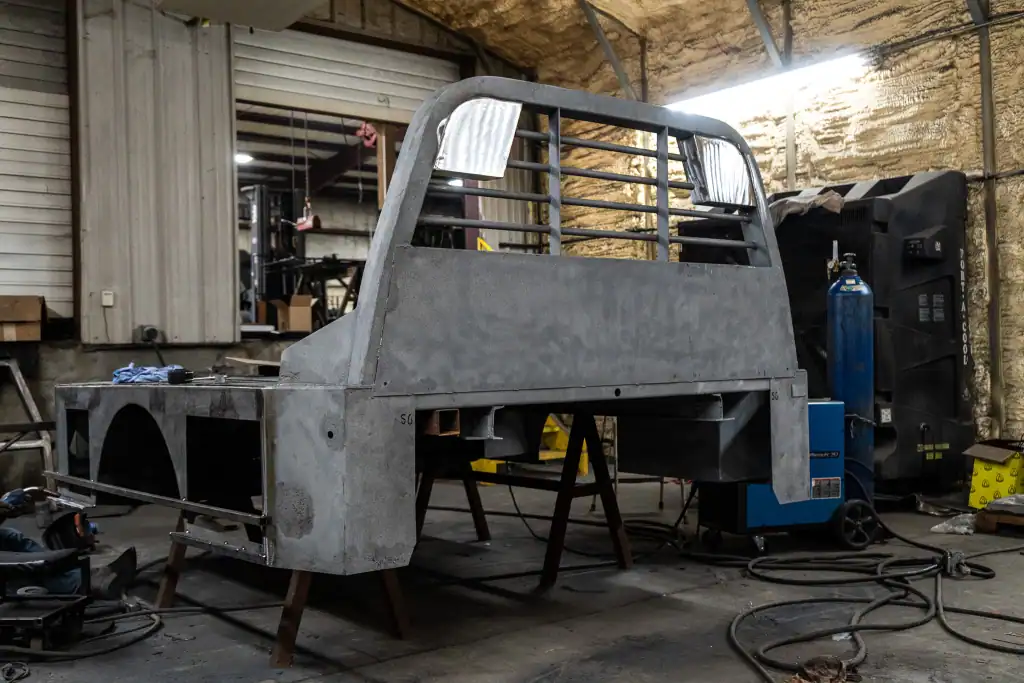 Custom metal truck bed fabrication for industrial powder coating applications.