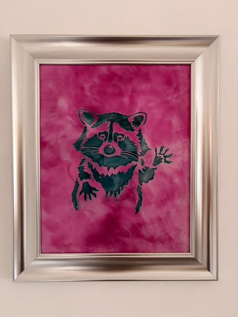 Vibrant pink background with a raccoon illustration in black and white.