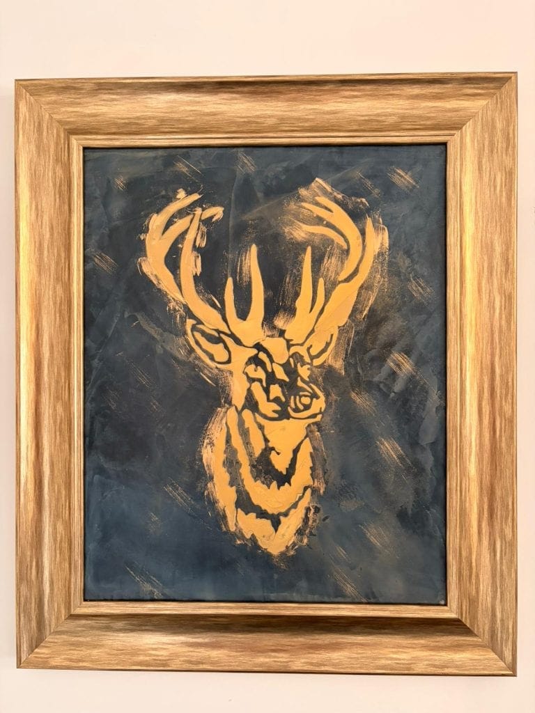 Abstract deer head painting with bold orange strokes on dark background.