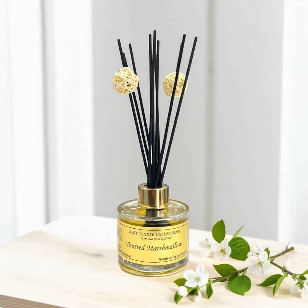 Elegant toasted marshmallow reed diffuser with black reeds and decorative balls.