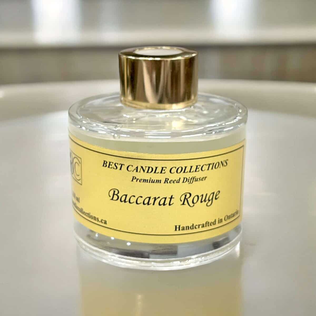 Reed diffuser in a clear glass bottle with a gold cap, labelled "Baccarat Rouge" for luxurious home.