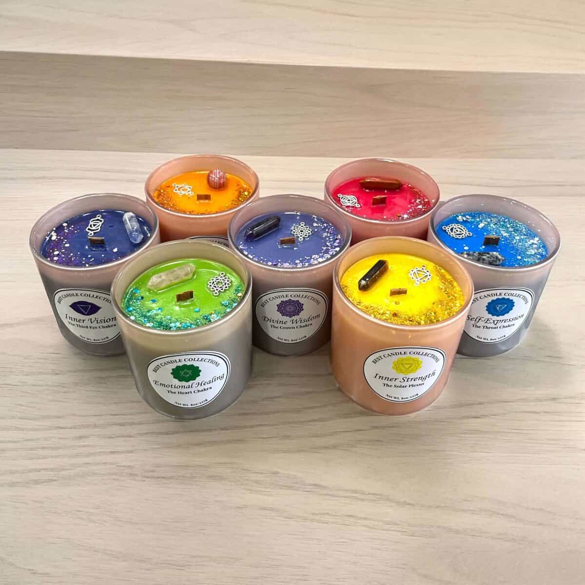 Assorted chakra soy candles in vibrant colours for spiritual healing and relaxation.