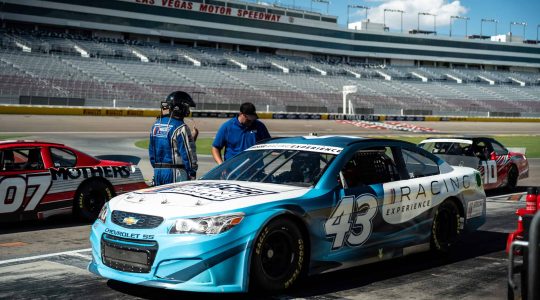 Chevrolet race car at Las Vegas Motor Speedway, featuring Big Balls Brotherhood branding, with team members preparing for a track event.
