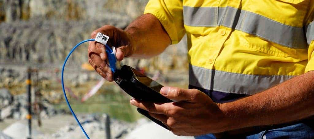 A BME technician prepares the AXXIS electronic detonator - ensuring precise, data-driven blasting that enhances safety, fragmentation, and environmental control.