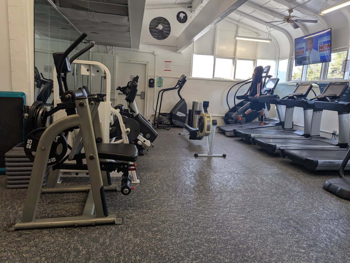 Weight room at Bay-O-Vista Swim & Tennis Club featuring modern cardio and strength equipment for members.