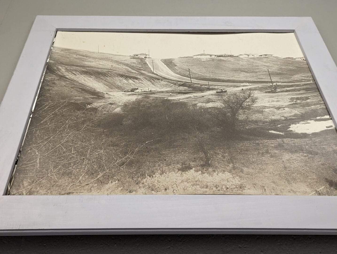 A black-and-white historical photograph of the Bay-O-Vista area showing early construction roads and landscape features.