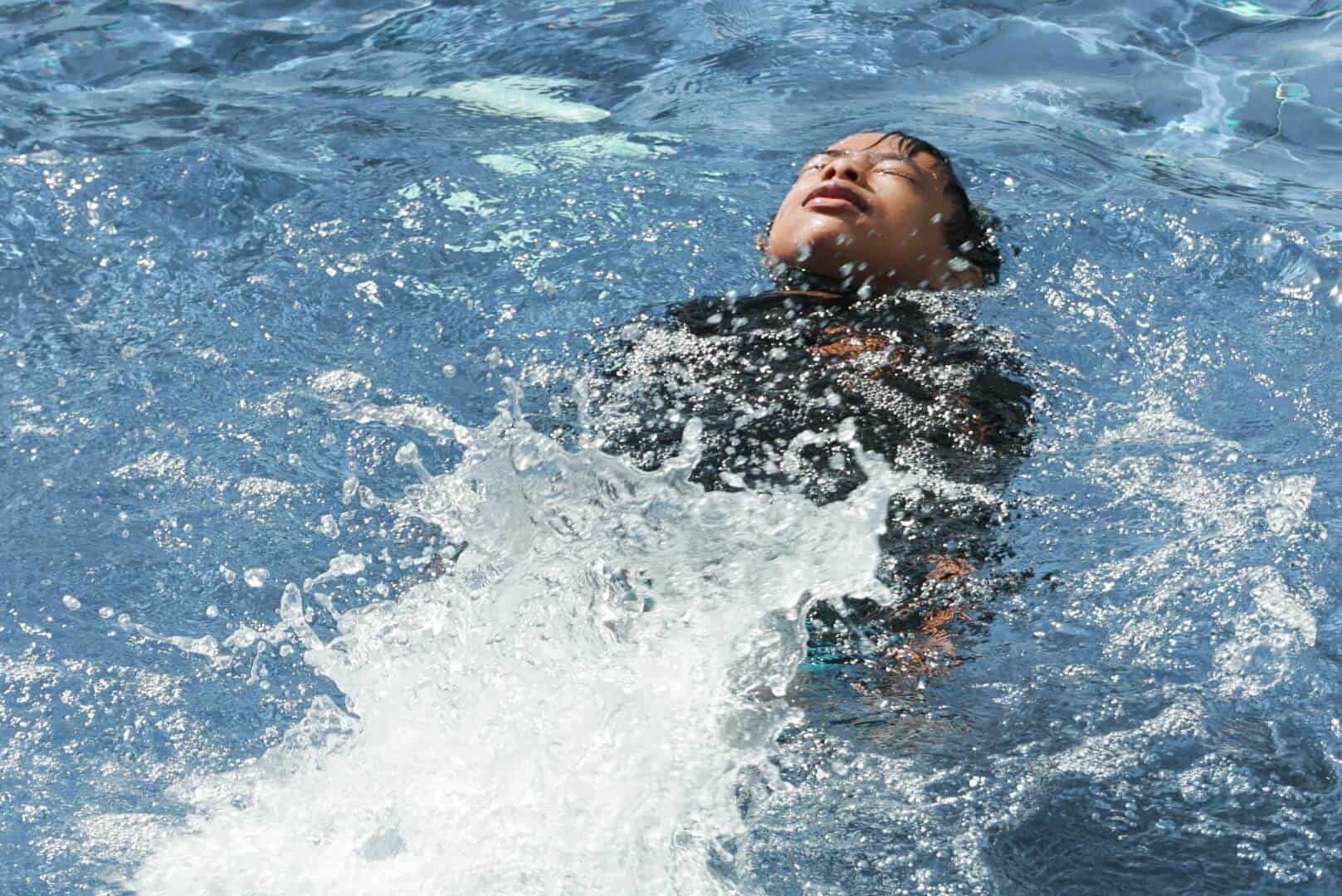 Kids swimming and enjoying aquatic activities at Bay-O-Vista Swim & Tennis Club, a premier community with swimming pools, tennis courts, and family-friendly amenities.