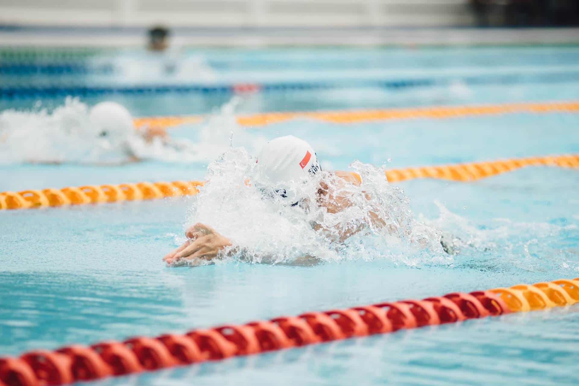 Swimmer practicing competitive swimming at Bay-O-Vista Swim & Tennis Club in a pool with orange lane dividers.