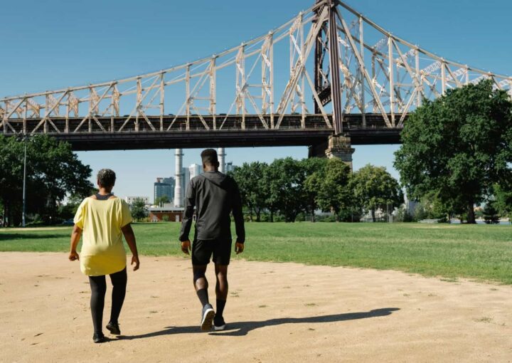 Bright sunny day at Bay-O-Vista Swim & Tennis Club, featuring outdoor activities, tennis courts, and scenic views of bridges and city skyline for recreation and community events.