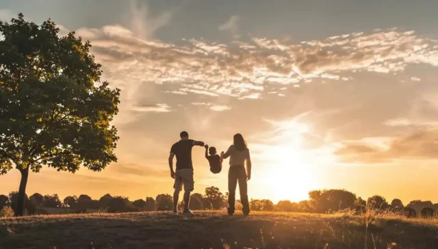 Family enjoying an active outdoor day together at sunset