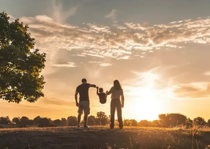 Family enjoying an active outdoor day together at sunset