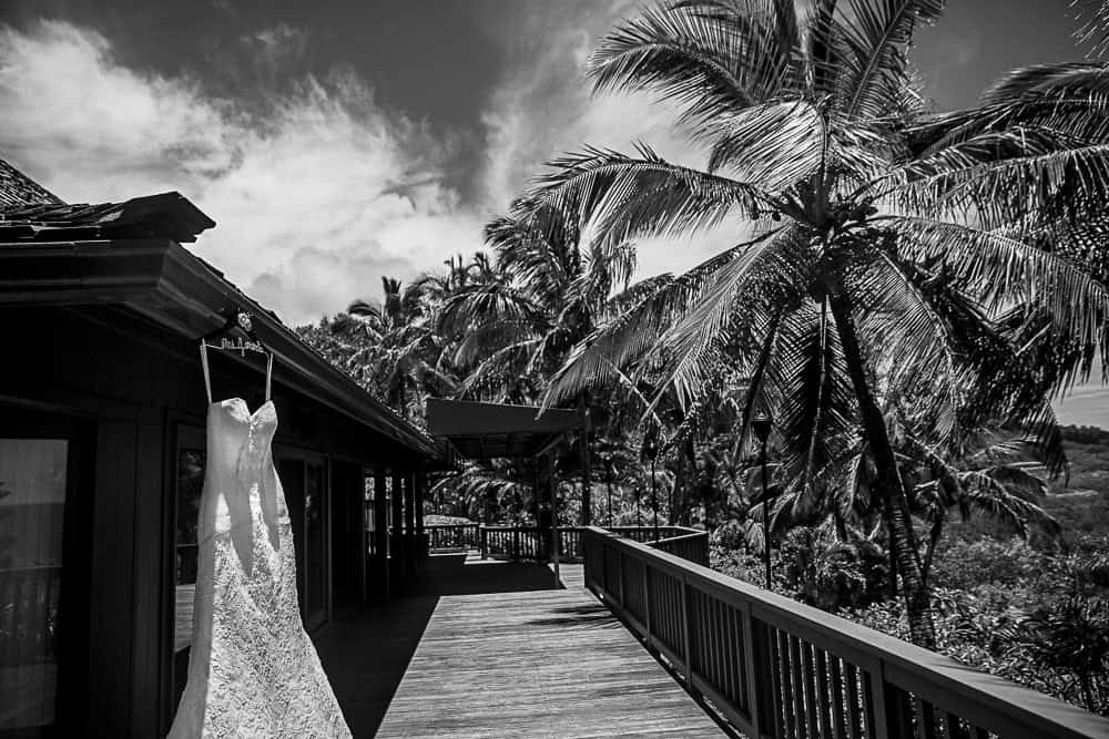 hawaii wedding dress A beautiful black and white wedding photo featuring a dress on a porch.
