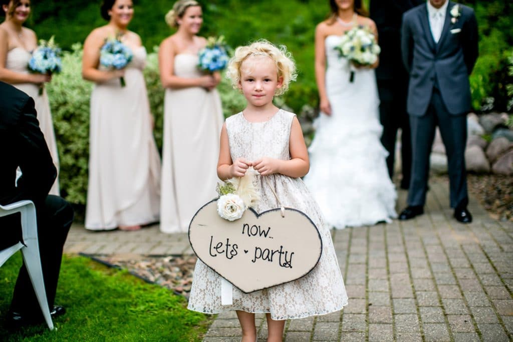 Drugans wedding A moody wedding photo capturing a little girl holding a sign that says i love you.