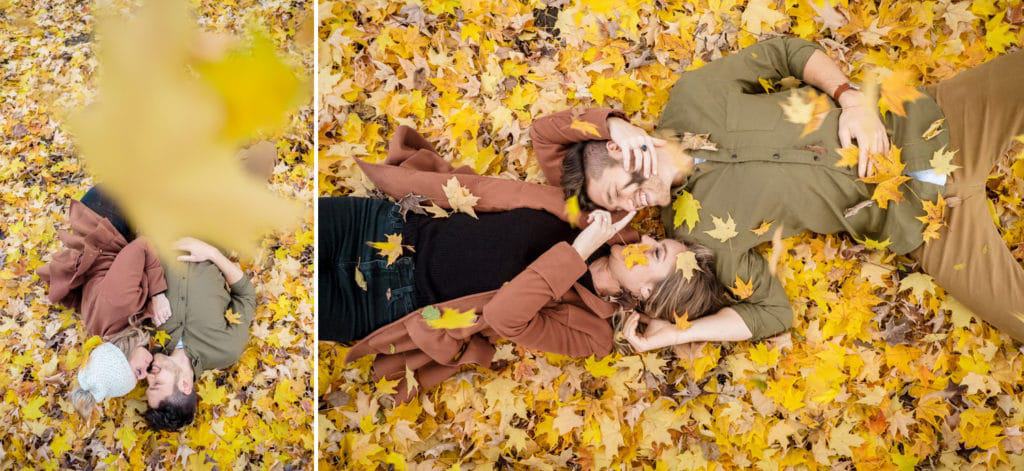Perot State Park Engagement A couple laying down in a field of yellow leaves.
