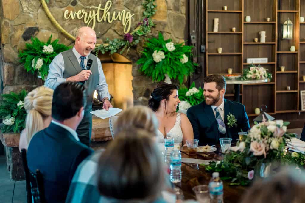 A groom giving a speech at a wedding reception.
