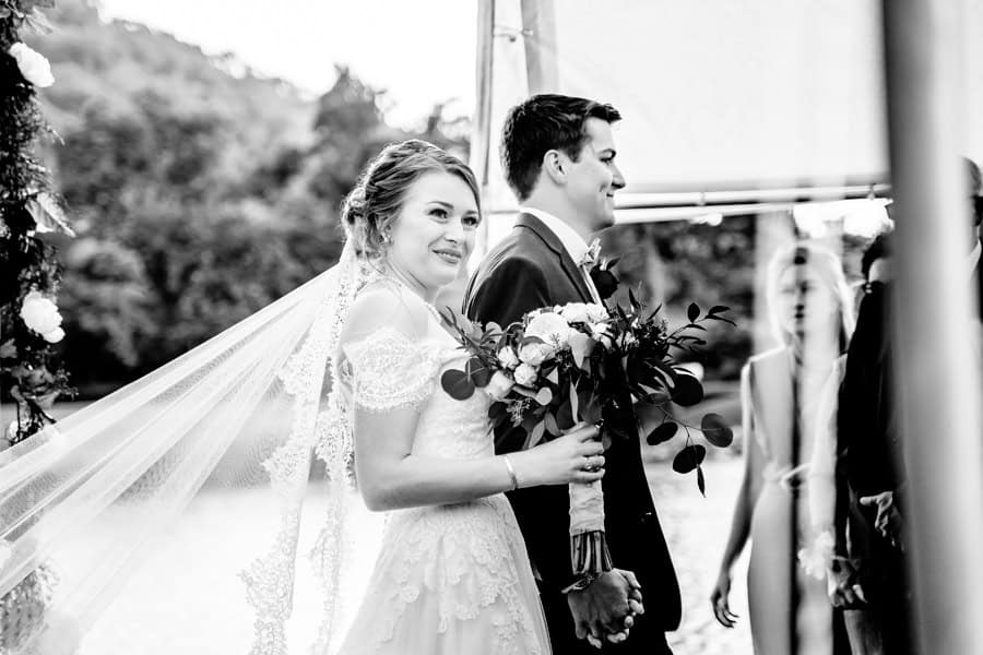 A bride and groom walking down the aisle at a wedding.