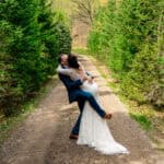 A bride and groom embracing in a love-filled backyard wedding.