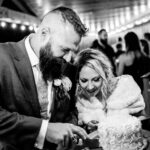 A couple in an emotional backyard wedding in La Crosse cutting their wedding cake.