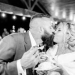 A blissful bride and groom enjoying a sweet moment at their emotional backyard wedding in La Crosse.